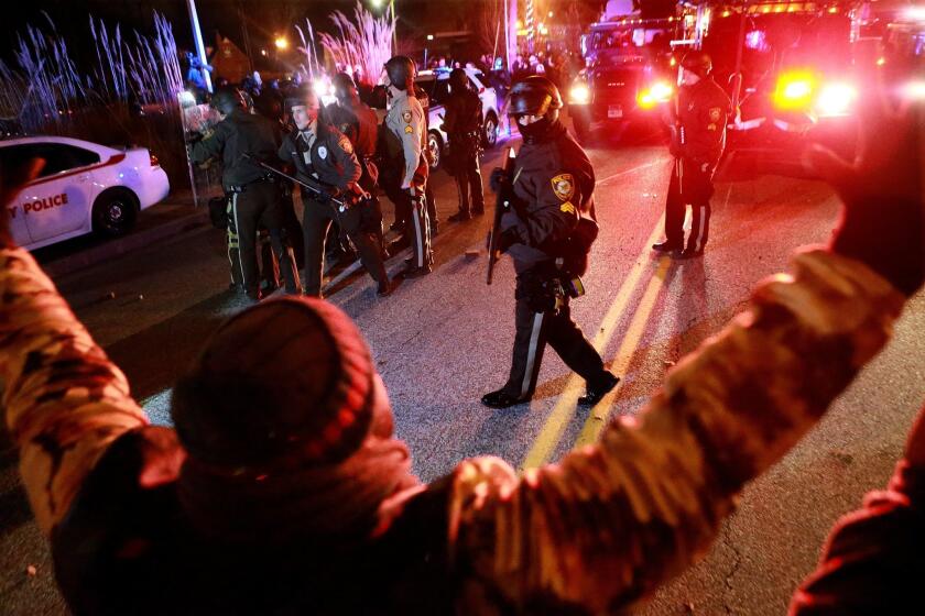 Police and protesters meet at a line on South Florissant Avenue on Nov. 24 in Ferguson, Mo., after a grand jury did not indict Ferguson police Officer Darren Wilson in the shooting death of unarmed, 18-year-old Michael Brown.