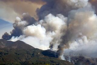 TRABUCO CANYON CALIF SEPTEMBER 10, 2024 - A firefighting helicopter battles the Airport fire, dropping retardant near Santiago Peak on Tuesday, Sept. 10, 2024. The Airport fire has charred more than 9,000 acres. (Allen J. Schaben / Los Angeles Times)