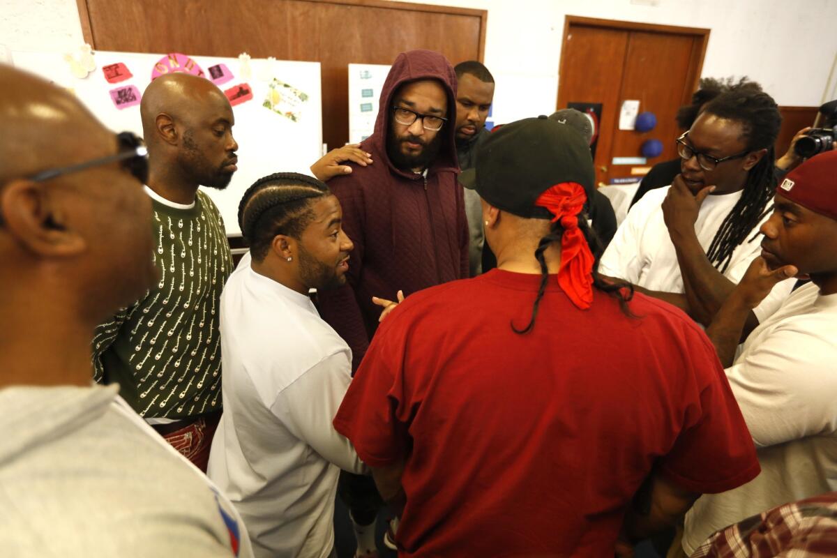 Laurence "Boogalue" Cartwright of Campanella Park Pirus, third from left, negotiates with members of other Piru gangs about how to quell conflicts that originate on social media.