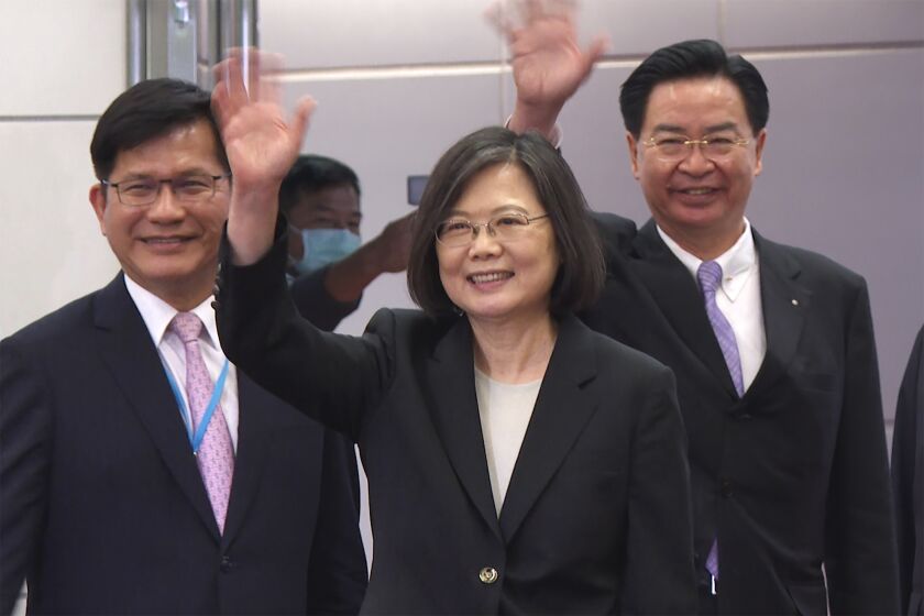 In this image made from video, Taiwan's Presidential office secretary general Lin Chia-lung, left, President Tsai Ing-wen, center, and Foreign Minister Joseph Wu wave before Tsai's departure on an overseas trip at Taoyuan International Airport in Taipei, Taiwan, Wednesday, March 29, 2023. China has threatened "resolute countermeasures" over a planned meeting between Taiwanese President Tsai Ing-wen and Speaker of the United States House Speaker Kevin McCarthy during an upcoming visit in Los Angeles by the head of the self-governing island democracy. (AP Photo/Johnson Lai)