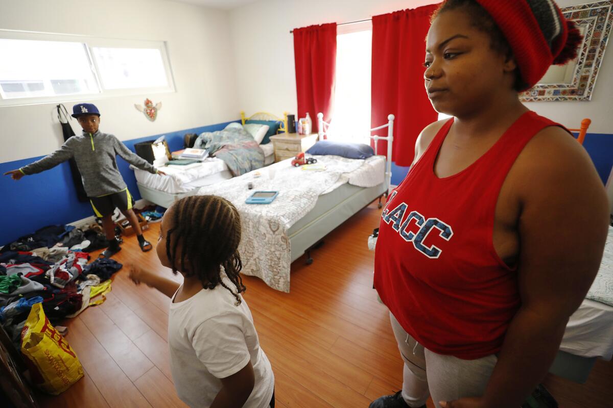 Anna Gray in her room that she shares with her children, Harold, 9, and Patrick, 5, at a recently opened temporary shelter.