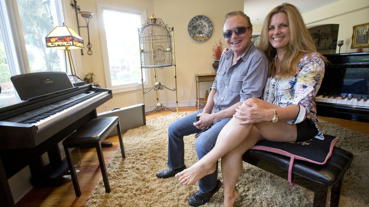 David Cassidy and girlfriend Maura Rossi in the living room of his Florida home that was auctioned off Sept. 9, the day he's accused of leaving the scene of an accident while driving on a suspended license.