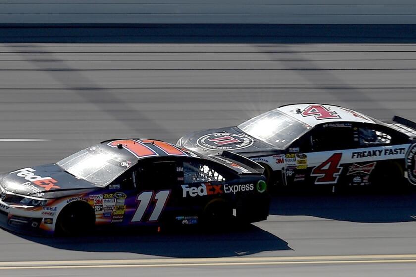NASCAR driver Denny Hamlin, in the No. 11 FedEx Express Toyota, leads Kevin Harvick, in the No. 4 Jimmy John's Chevrolet, during the NASCAR Sprint Cup Series Aaron's 499 at Talladega Superspeedway on Sunday.
