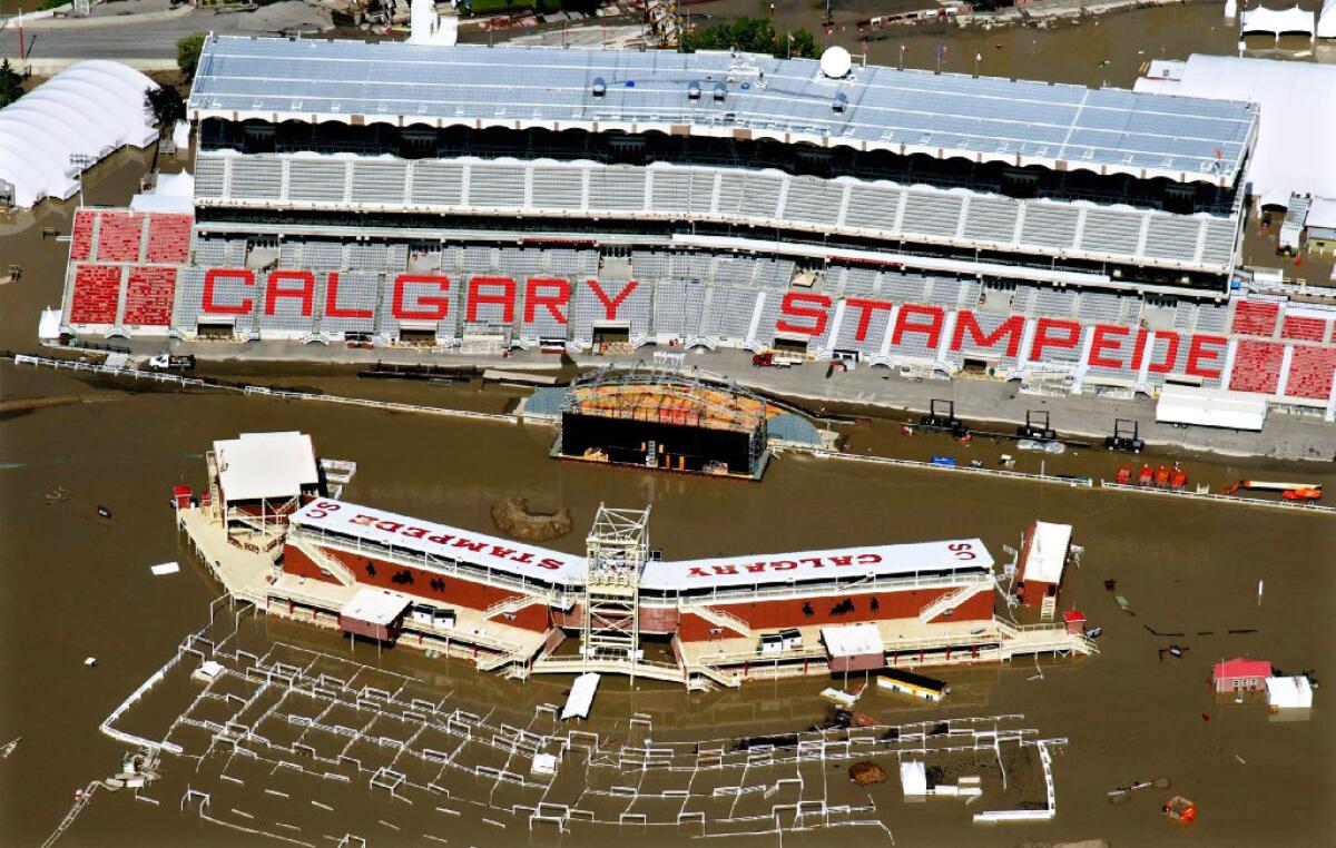 Workers raced to repair damage caused by water, shown in this June 22 photo, that flooded Calgary Stampede Stadium in Calgary, Alberta. The Stampede is scheduled to begin Friday, when more rain is expected.