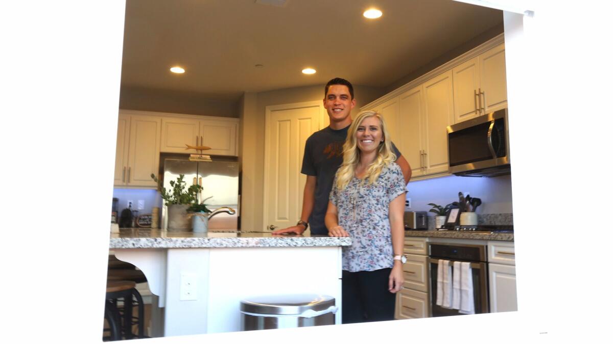 Josh and Kayleigh Hyink stand in the kitchen of their new home in Murrieta.