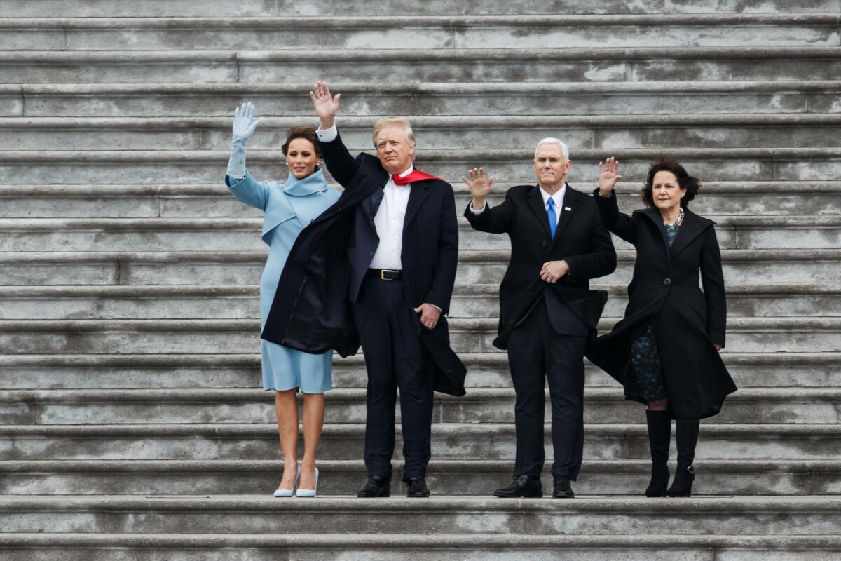 President Trump, Vice President Mike Pence and their spouses wave to the helicopter carrying former President Obama and the first family.