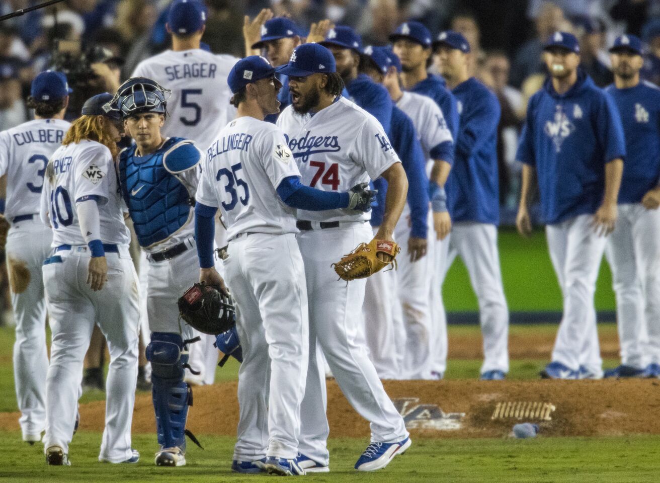 Kenley Jansen embraces Cody Bellinger after the Dodgers win game 6.