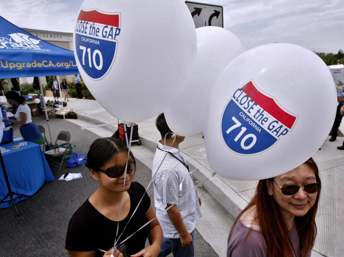 Supporters of the 710 Freeway extension carry balloons during the City of Alhambra "710 Day" celebration on Wednesday, July 10, 2013. Los Angeles County transportation officials announced Friday that the draft Environmental Impact Report for the 710 Freeway extension project is now anticipated for a February 2015 release.
