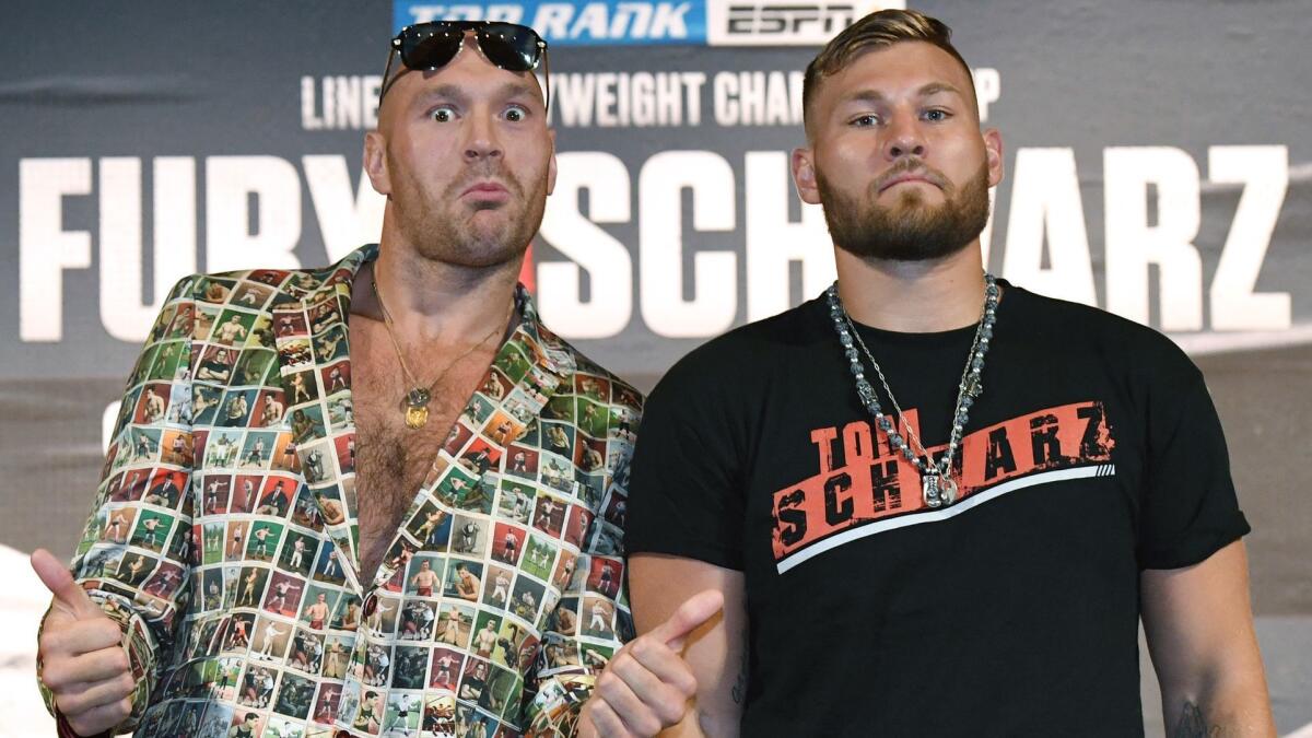 Boxers Tyson Fury, left, and Tom Schwarz pose during a news conference at MGM Grand Hotel & Casino on Wednesday.