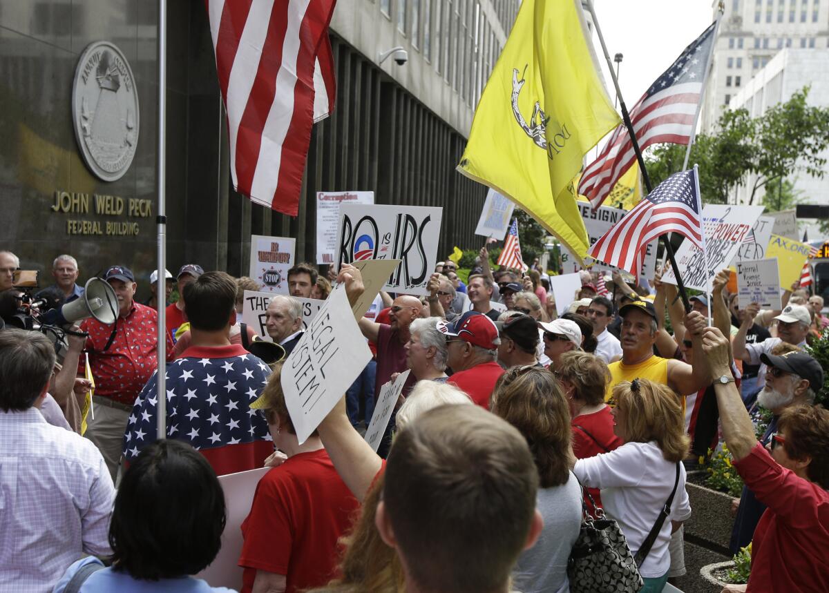 Tea party activists demonstrate outside the John Weld Peck Federal Building in Cincinnati. The building houses the main offices for the Internal Revenue Service in the city and is tied to the targeting of conservative groups.