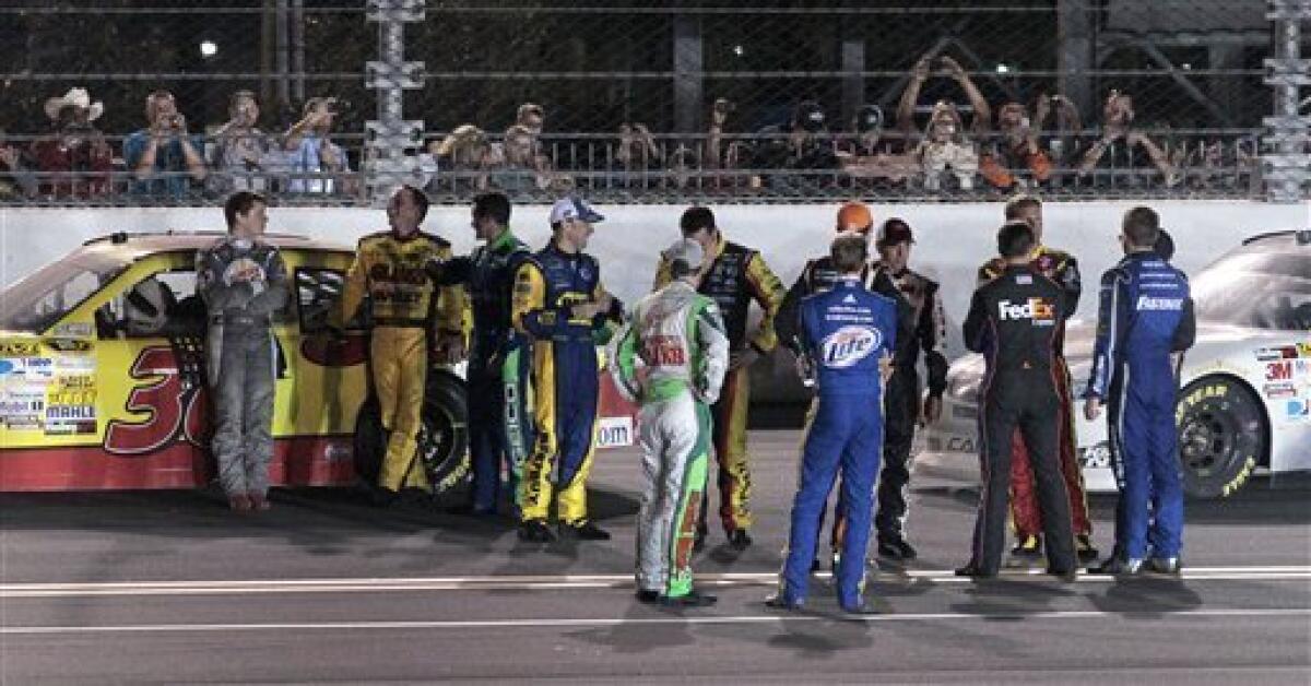 Race leader Dave Blaney, second from left, talks with Landon Cassill, left, as other drivers gather during a red flag in the NASCAR Daytona 500 auto race at Daytona International Speedway in Daytona Beach, Fla., Monday, Feb. 27, 2012. (AP Photo/Bill Friel)