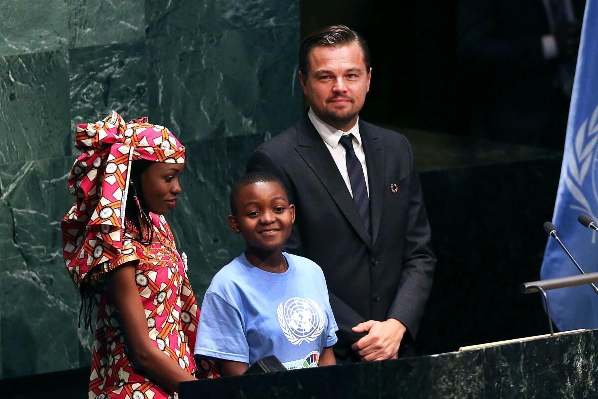 Leonardo DiCaprio stands with children at the United Nations signing ceremony for the Paris agreement on climate change.
