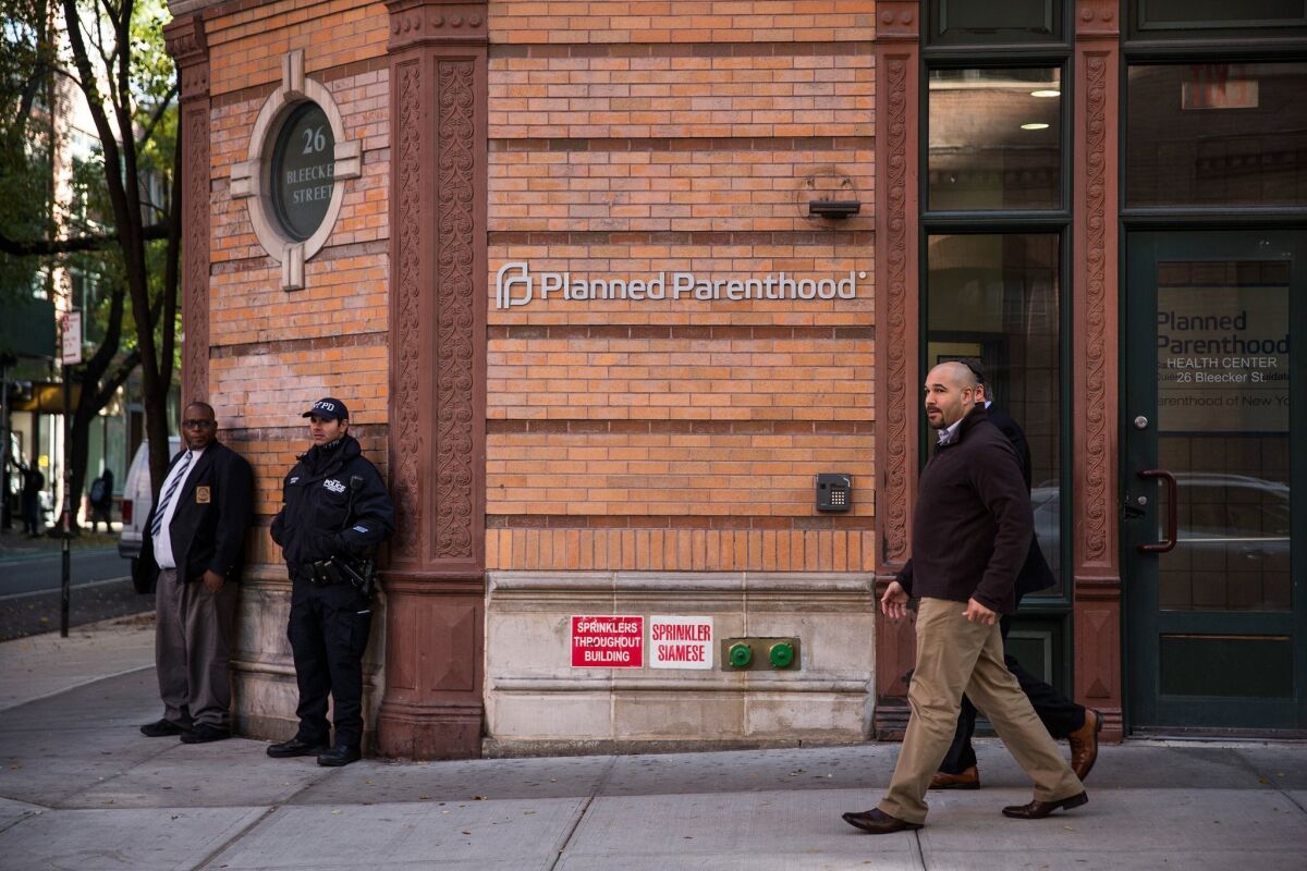 A police officer from NYPD's counterterrorism department stands guard outside a Planned Parenthood clinic in New York City on Nov. 30.