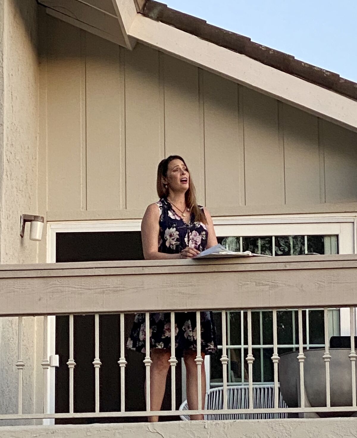 La Jolla resident and professional opera singer Alina Mullen performs for her neighbors from her balcony.