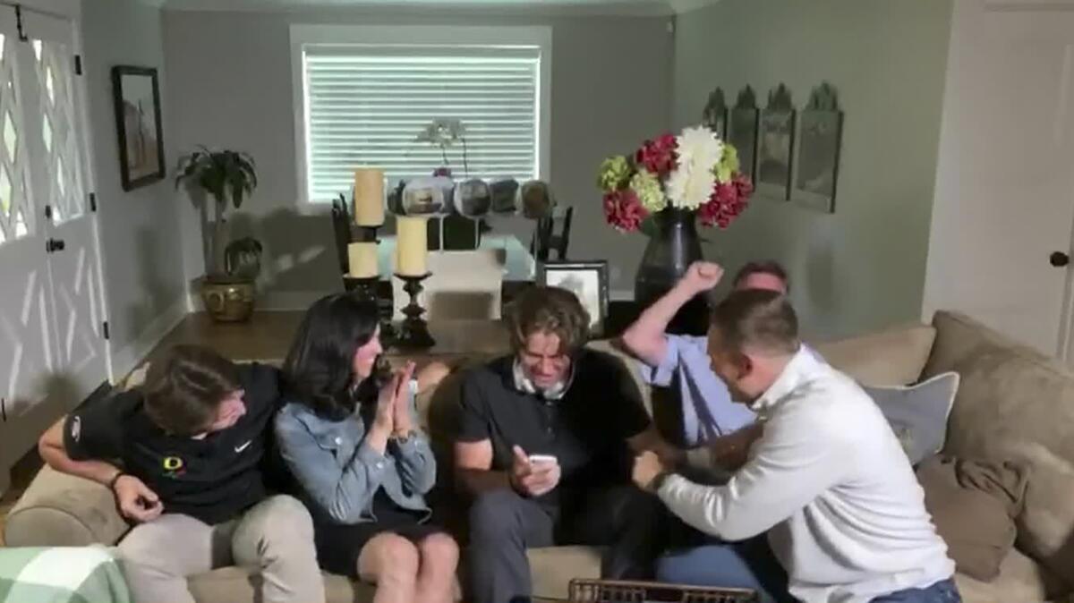 Former Oregon quarterback Justin Herbert is surrounded by his family during the 2020 NFL draft.