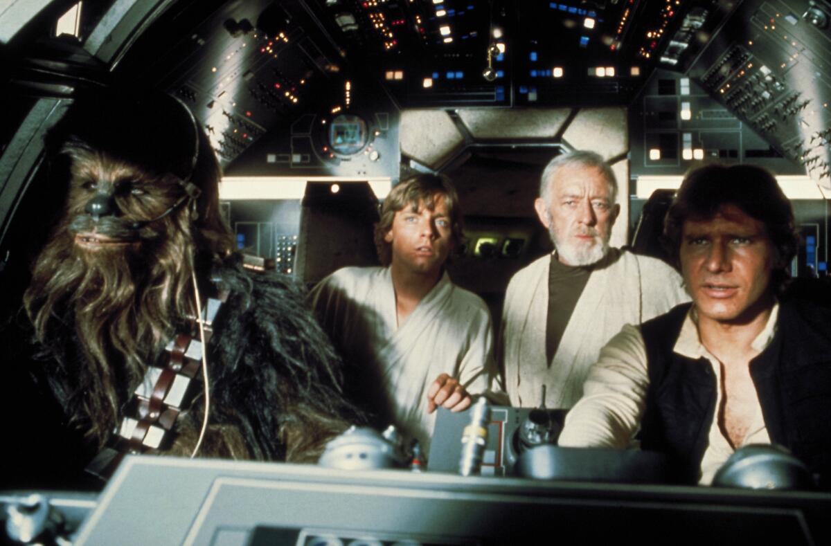 Peter Mayhew, left, Mark Hamill, Alec Guinness and Harrison Ford in a cockpit