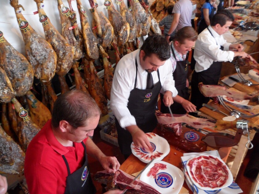 Chefs prepare jamon (ham) for festivalgoers at a previous Latin Food Fest.