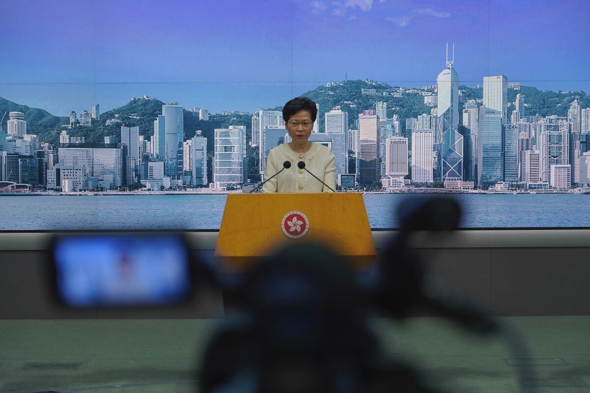 Hong Kong Chief Executive Carrie Lam listens to reporters' questions during a press conference in Hong Kong, Tuesday, July 7, 2020. TikTok said Tuesday it will stop operations in Hong Kong, joining other social media companies in warily eyeing ramifications of a sweeping national security law that took effect last week.(AP Photo/Vincent Yu)