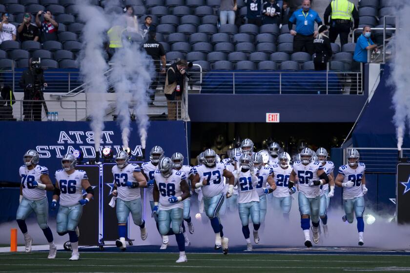 The Dallas Cowboys run onto the field during an NFL football game against the Philadelphia Eagles.