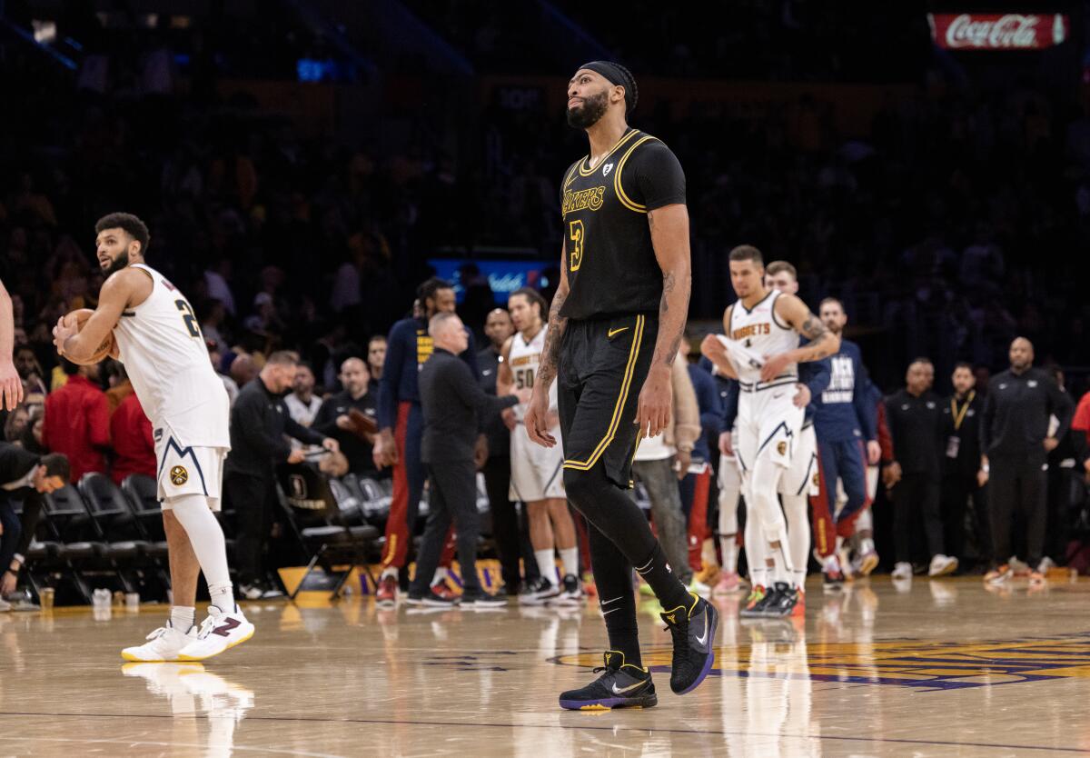 Lakers forward Anthony Davis walks off the court after a 114-106 loss to the Denver Nuggets at Crypto.com Arena on Thursday.