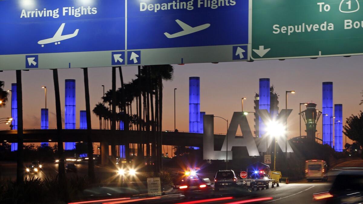 Lighted pylons at the Century Boulevard entrance to Los Angeles International Airport, where parking may be tight.
