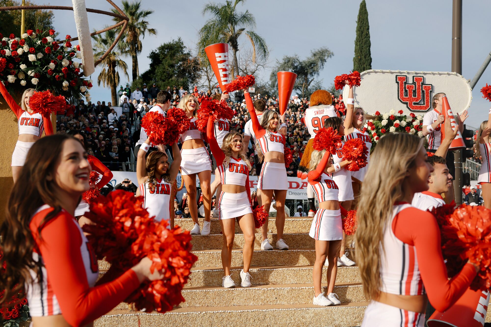 The Utah State Float and cheerleaders entertain the crowd at the Tournament of Roses Parade.