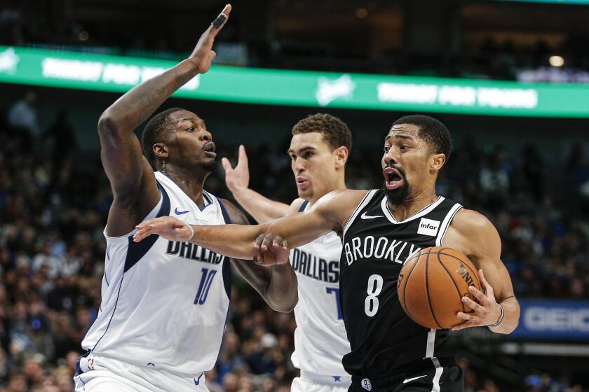 Mavericks forward Dorian Finney-Smith (10) and center Dwight Powell cut off a drive by Nets guard Spencer Dinwiddie during a game Jan. 2, 2020, in Dallas.