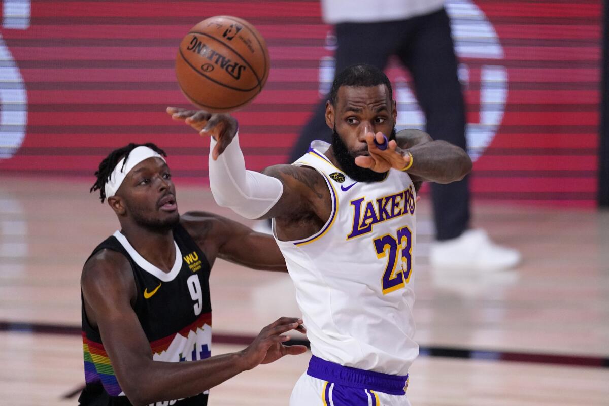 Lakers forward LeBron James drives down the lane against Nuggets foward Jerami Grant during Game 3.