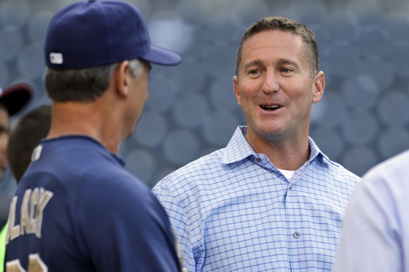 San Diego Padres general manager Josh Byrnes talks with manager Buddy Black before a baseball game against the Los Angeles Dodgers in San Diego, Wednesday, April 10, 2013. (AP Photo/Lenny Ignelzi)