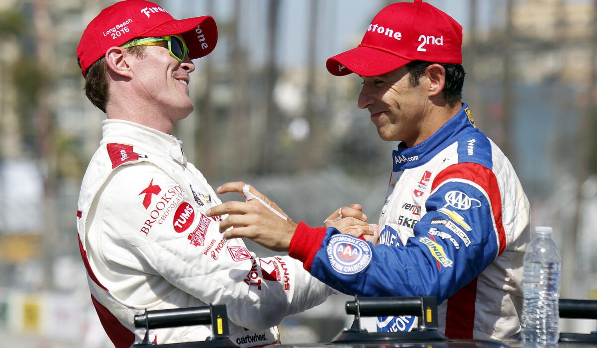 Scott Dixon, left, is congratulated by runner-up Helio Castroneves after winning the Toyota Grand Prix of Long Beach on Sunday.