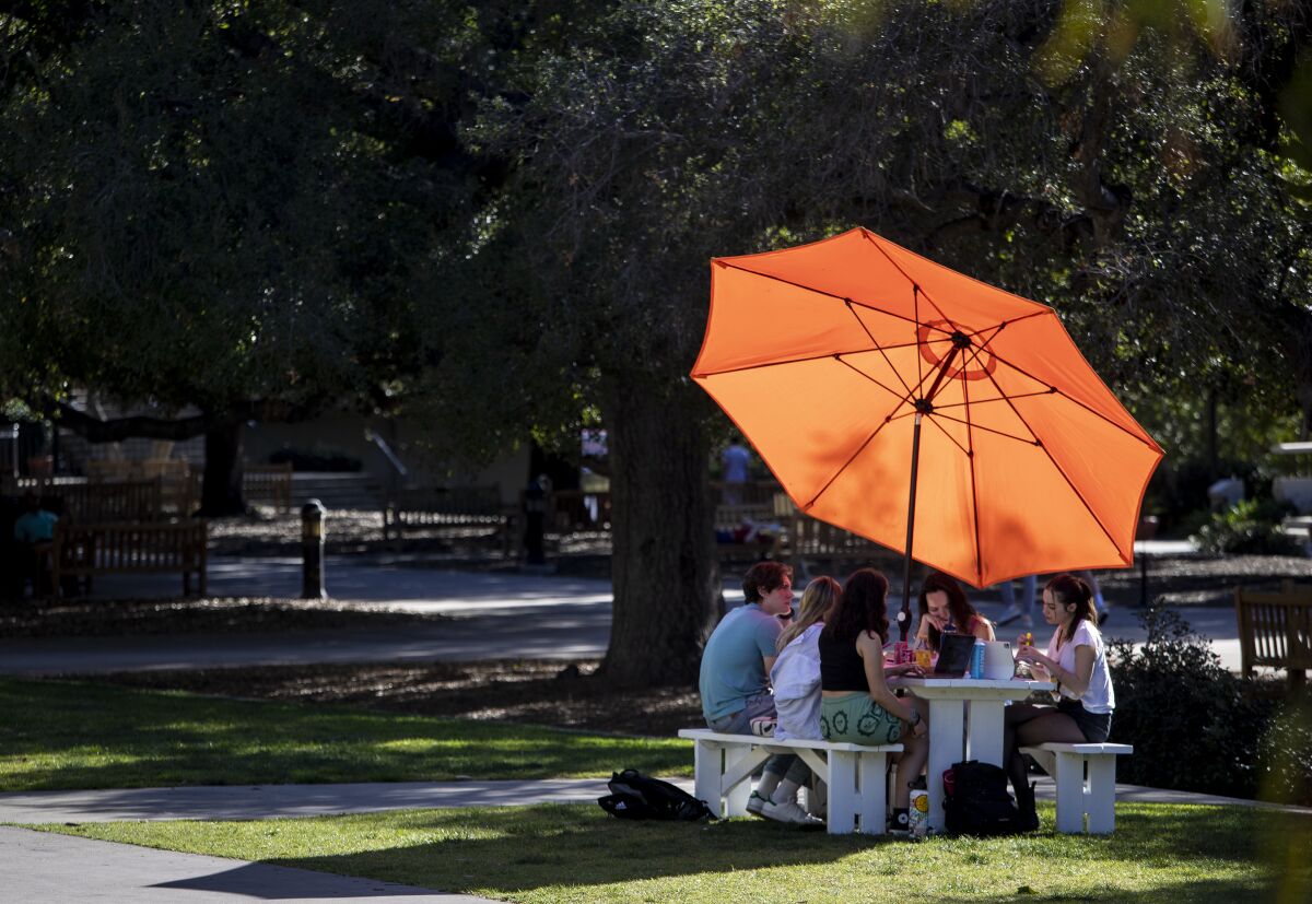 Students gather at a table at Occidental College in Los Angeles.