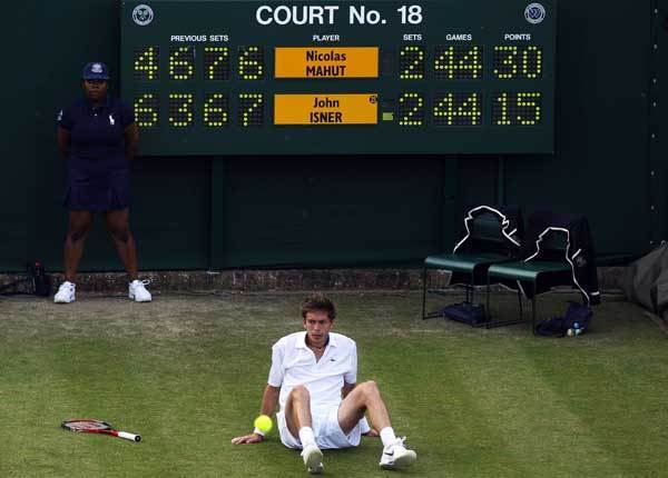 Nicolas Mahut reacts during his first round match against John Isner on Day Three of the Wimbledon Tennis Championships on June 23, 2010.
