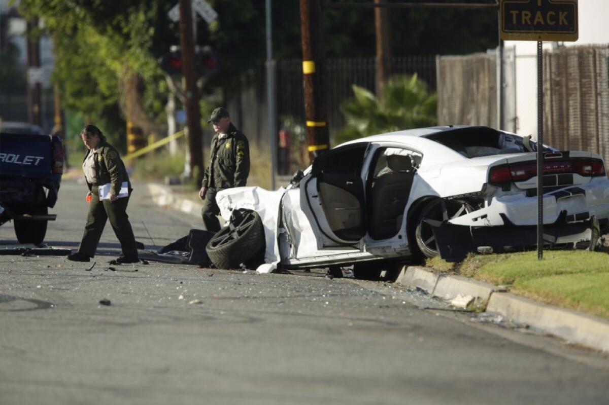 Los Angeles County sheriff's investigators collect evidence at the scene of a mutivehicle crash that left three people dead in Commerce early Saturday.