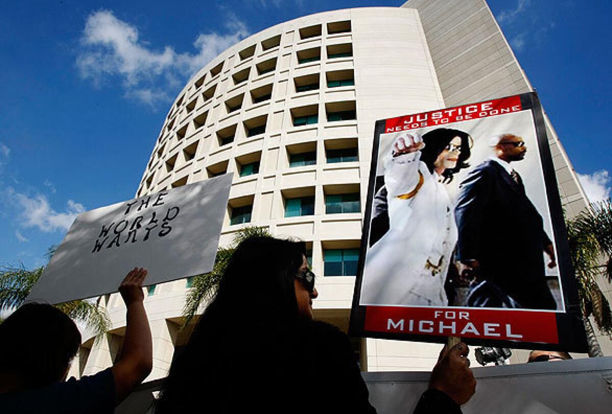 Fans of the late Michael Jackson stand outside the Airport Courthouse. The coroner's office ruled the pop icon's June 25, 2009, death a homicide and said the cause was "acute propofol intoxication" in conjunction with the effect of other sedatives that Dr. Conrad Murray has acknowledged providing.