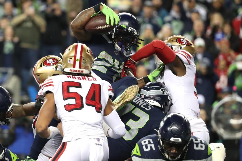 SEATTLE, WASHINGTON - DECEMBER 29: Marshawn Lynch #24 of the Seattle Seahawks leaps for a one yard touchdown against the San Francisco 49ers in the fourth quarter during their game at CenturyLink Field on December 29, 2019 in Seattle, Washington. (Photo by Abbie Parr/Getty Images)