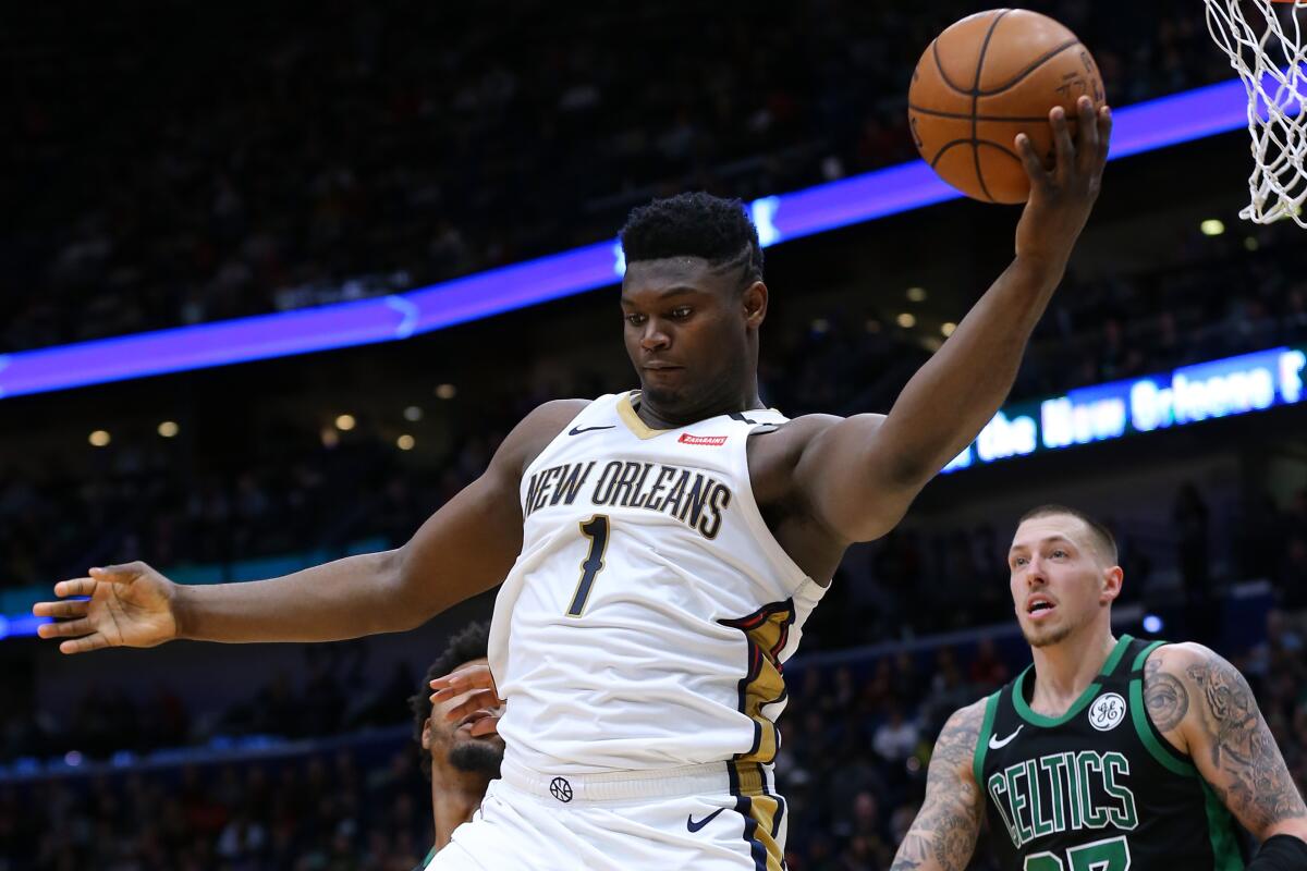 Pelicans forward Zion Williamson grabs a rebound during a game against the Celtics on Jan. 26.