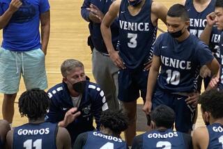 Venice basketball coach David Galley talks to his team.