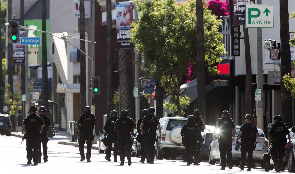 LAPD SWAT officers walk toward shooting scene on Ventura Blvd. in Studio City.
