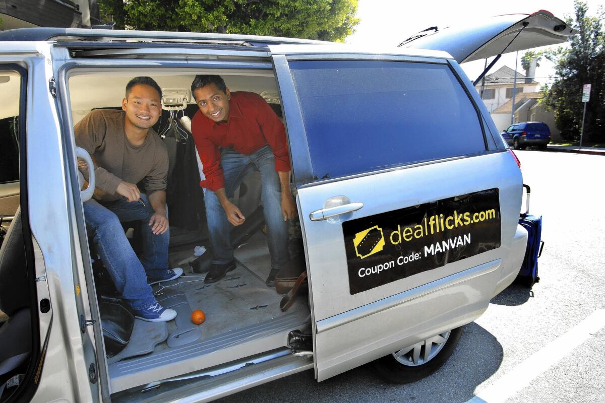 Dealflicks co-founders Kevin Hong, left, and Sean Wycliffe are inside a converted minivan the company uses to travel around the country and meet with theater owners.