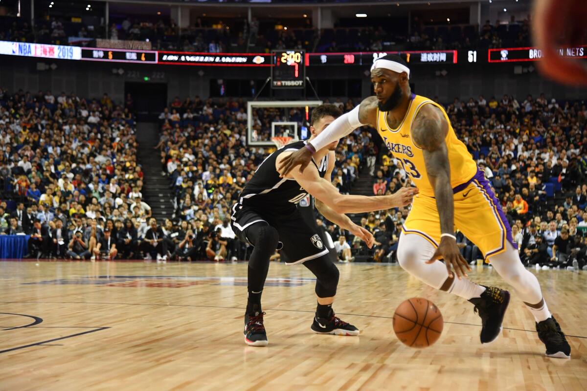 Lakers forward LeBron James drives to the basket against the Nets during their game Oct. 10 in Shanghai.