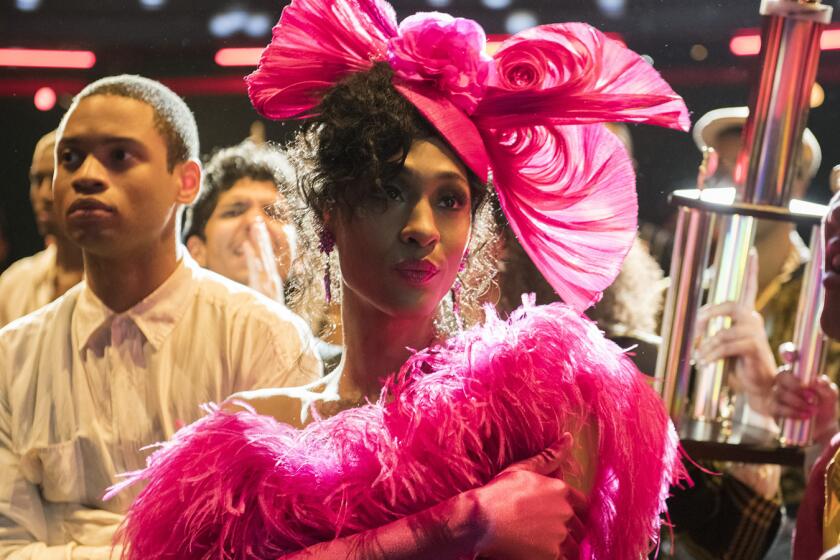 Mj Rodriguez wearing a hot pink hat and feather dress in "Pose"