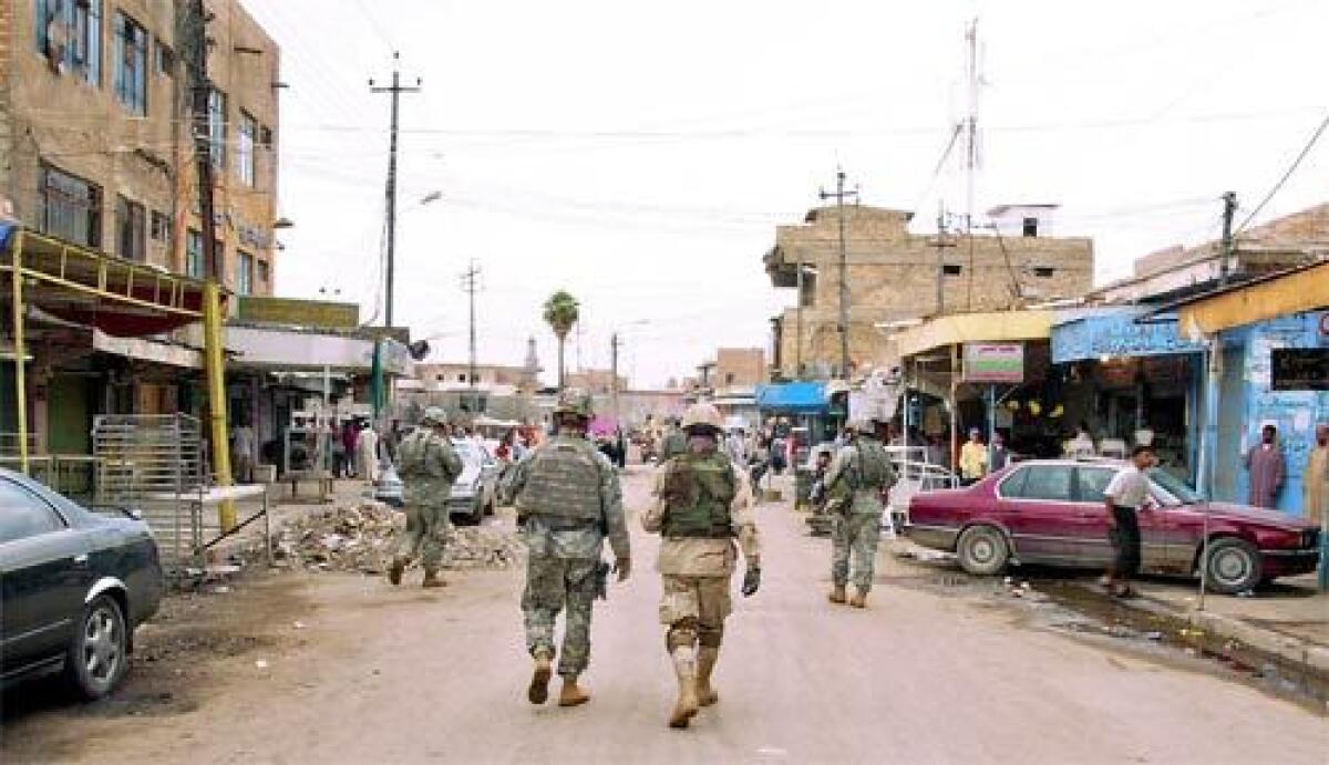 Foot patrol: U.S. soldiers conduct sweeps throught the streets of downtown Balad on Thursday, Oct. 26, 2006.