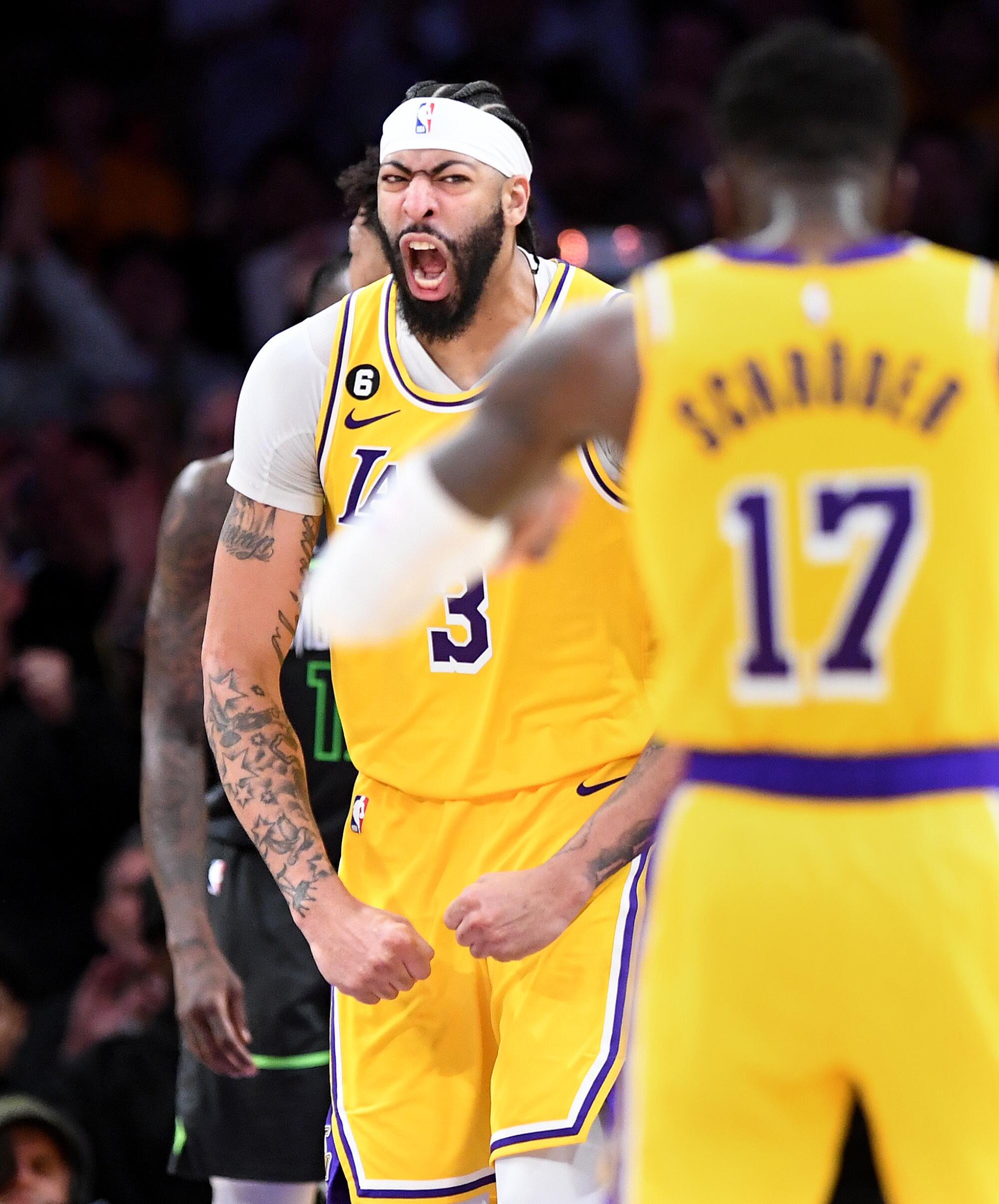 The Lakers' Anthony Davis celebrates scoring against the Timberwolves in overtime Tuesday