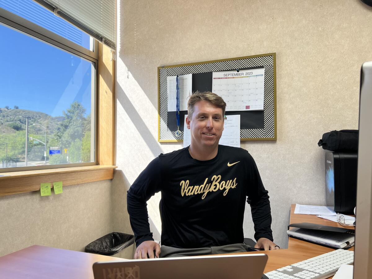 Calabasas baseball coach and athletic director Thomas Cassidy sits at his desk.