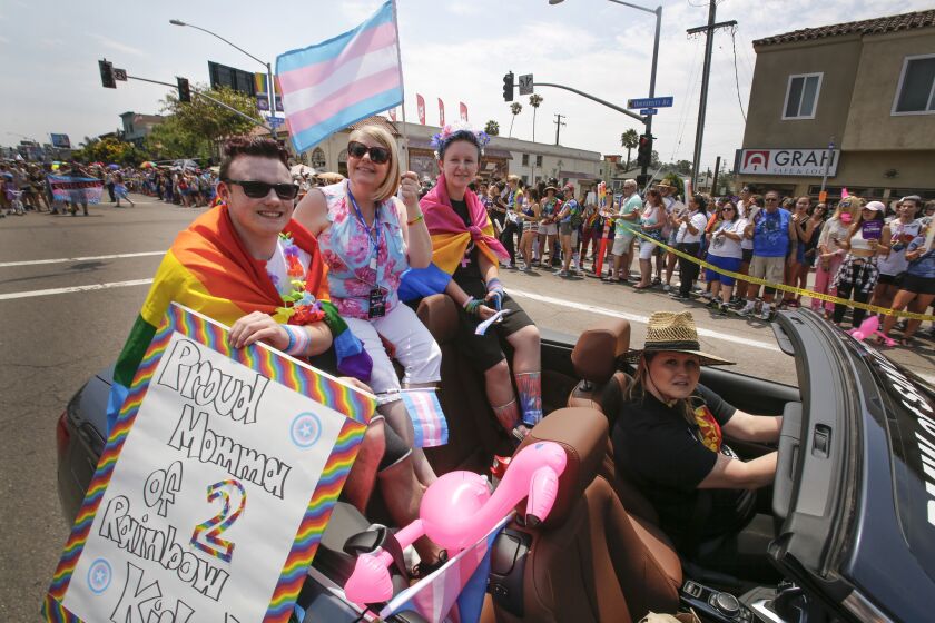Sam Moehlig, foreground, and his mom, Kathie Moehlig, founder of TransFamily Support Services, the 2017 Friend of Pride reciepient, along with Augustus Lawson, Sam's boyfriend, ride in the San Diego Pride parade.