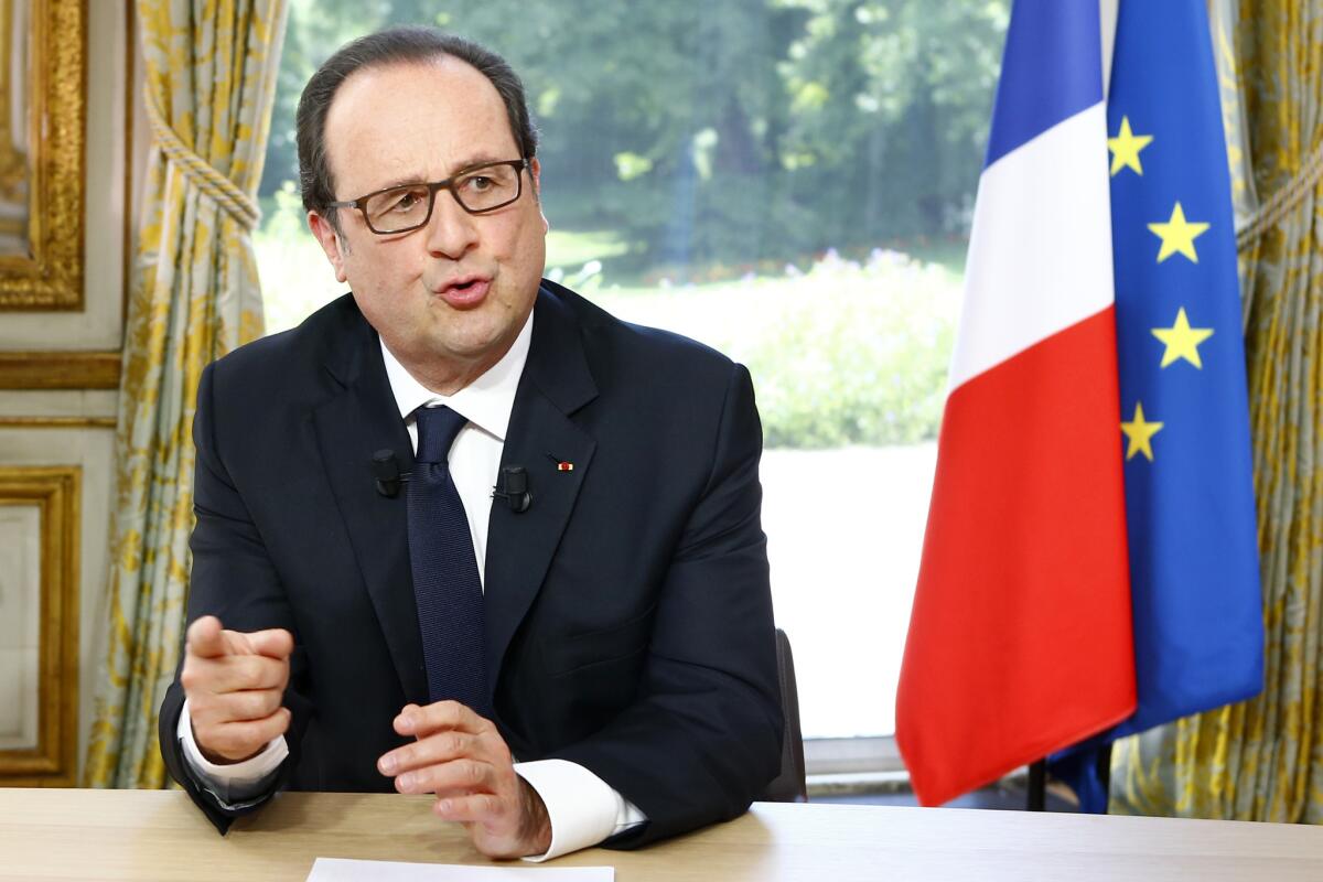 French President Francois Hollande gestures after a televised interview at the Elysee Palace following the Bastille Day parade in Paris on July 14.