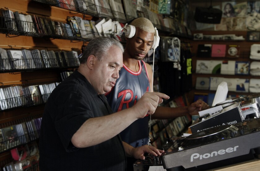 Bob Bagha, left, owner of Street Sounds Records in Los Angeles, gives a disc jockey lesson.