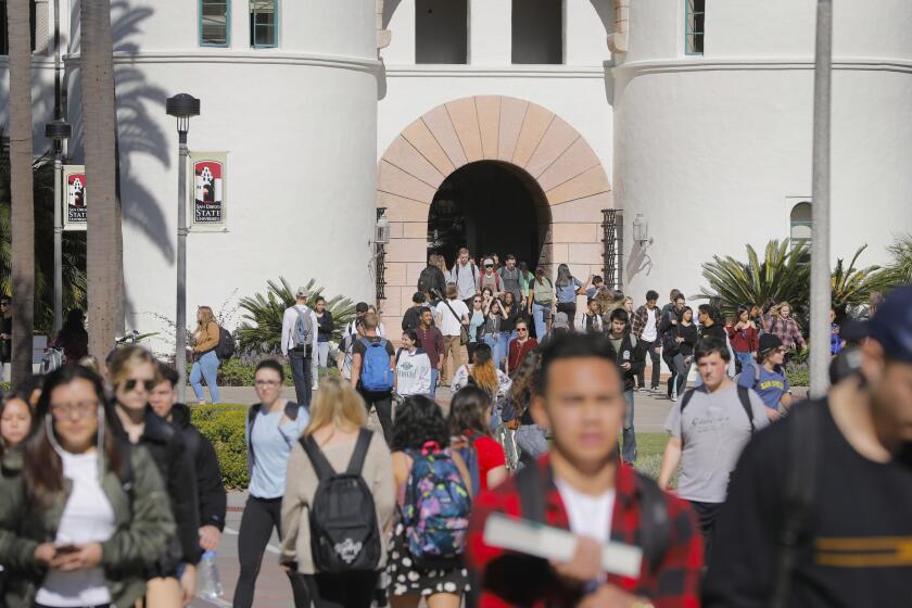 Howard Lipin  U-T Students leave Hepner Hall at San Diego State University, flowing onto the Campanile Walkway. College students in California are advised to check insurance options through Covered California.