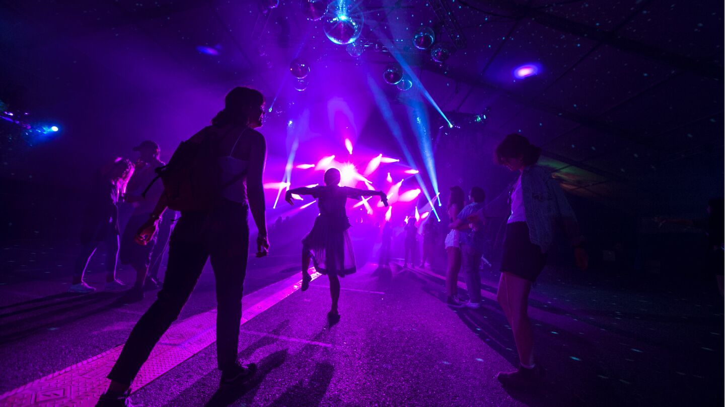 The mood stays light as people dance to house music before Survive takes the stage Friday night.