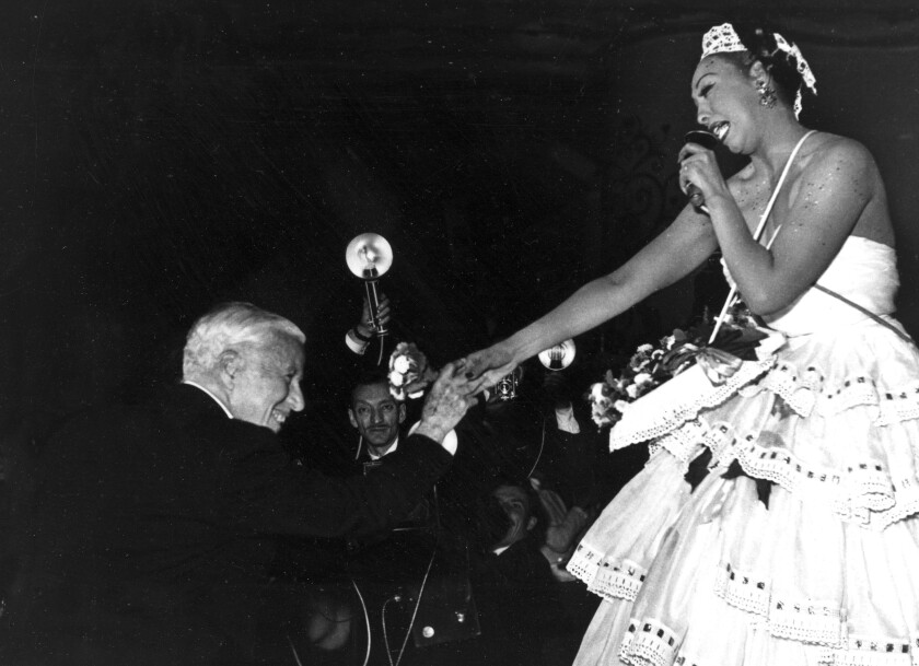Charlie Chaplin (izq) felicita a Josephine Baker tras una presentación de la estadounidense en el Moulin Rouge de París el 20 de mayo de 1953. (AP Photo, File)